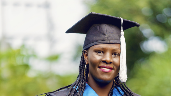 A woman wearing a mortarboard with a white tassel.