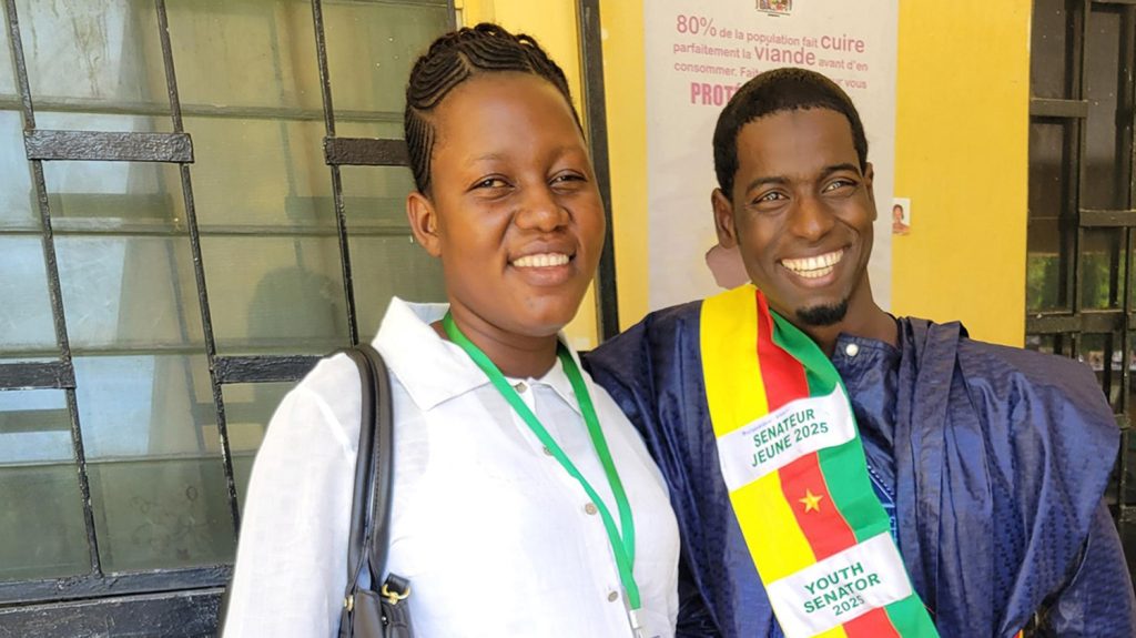Ousmanou and Magdalene smiling outside the local mayor's office in Maroua.
